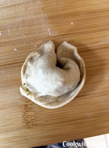 Crescent shaped momos on a board.