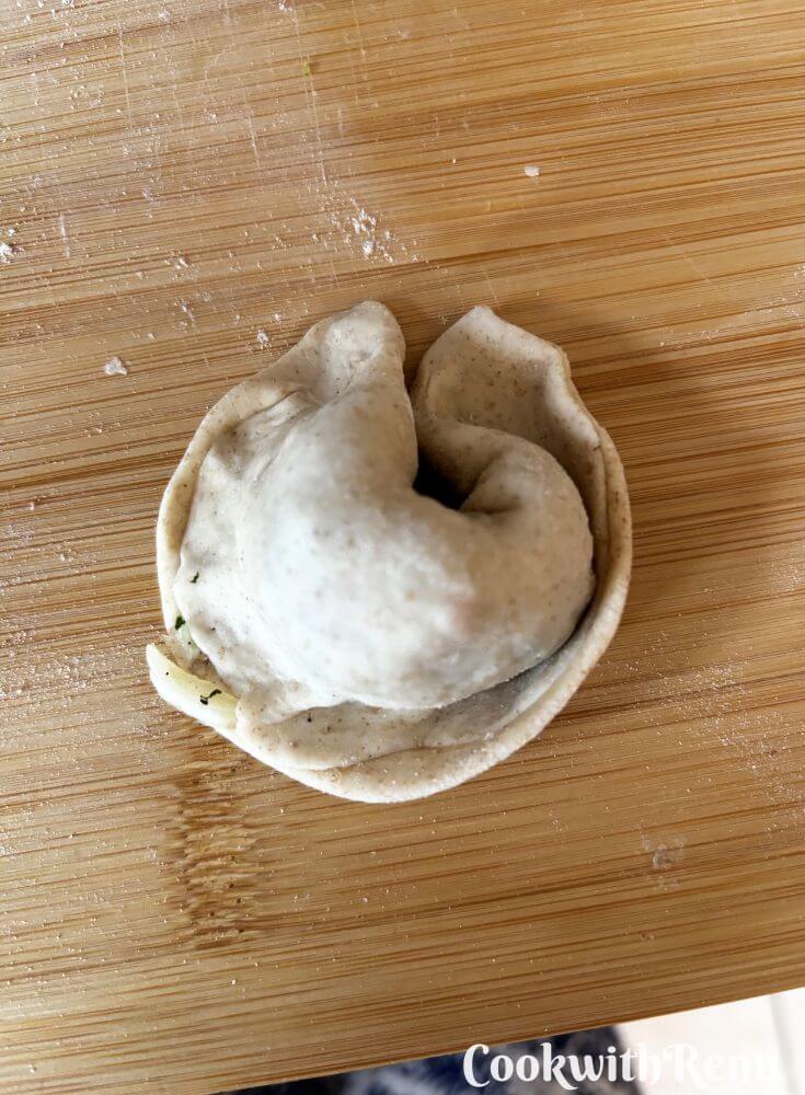 Crescent shaped momos on a board.