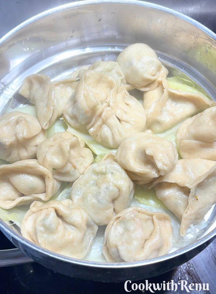 Steamed momos in a colander.