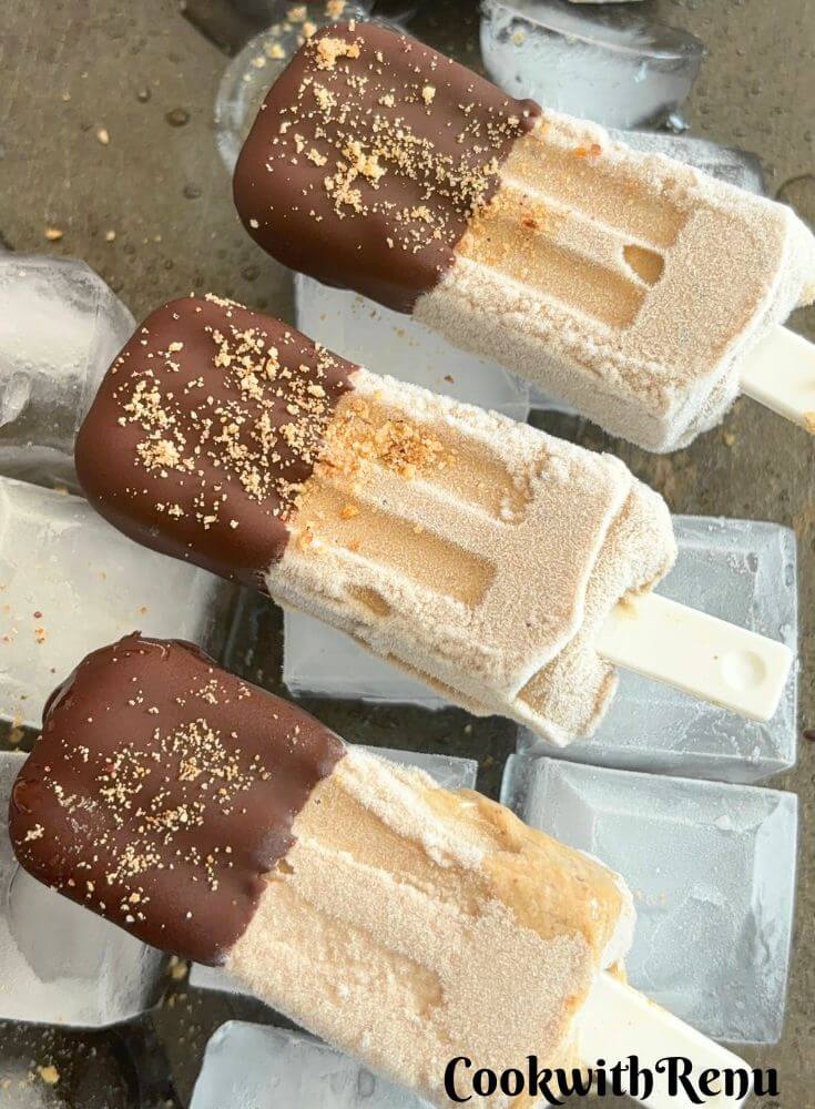 3 Banana Peanut Butter Ice Cream popsicles laid on a Ice Tray.