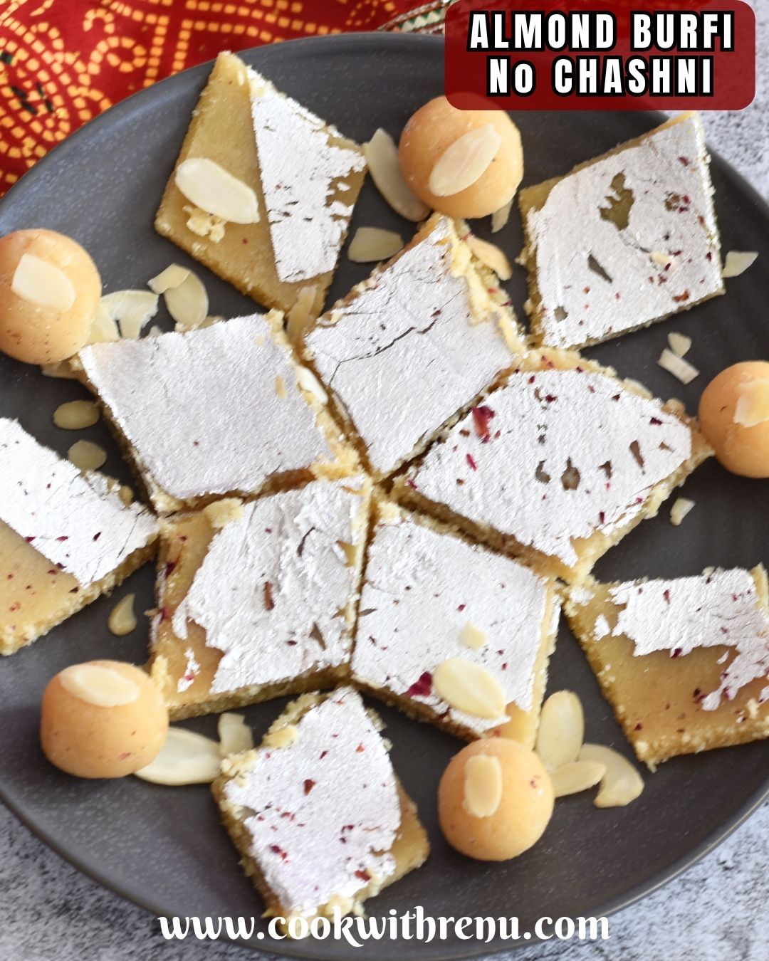 Almond Flour Burfi and Ladoo are arranged on a grey plate, with a red dupatta in the background.