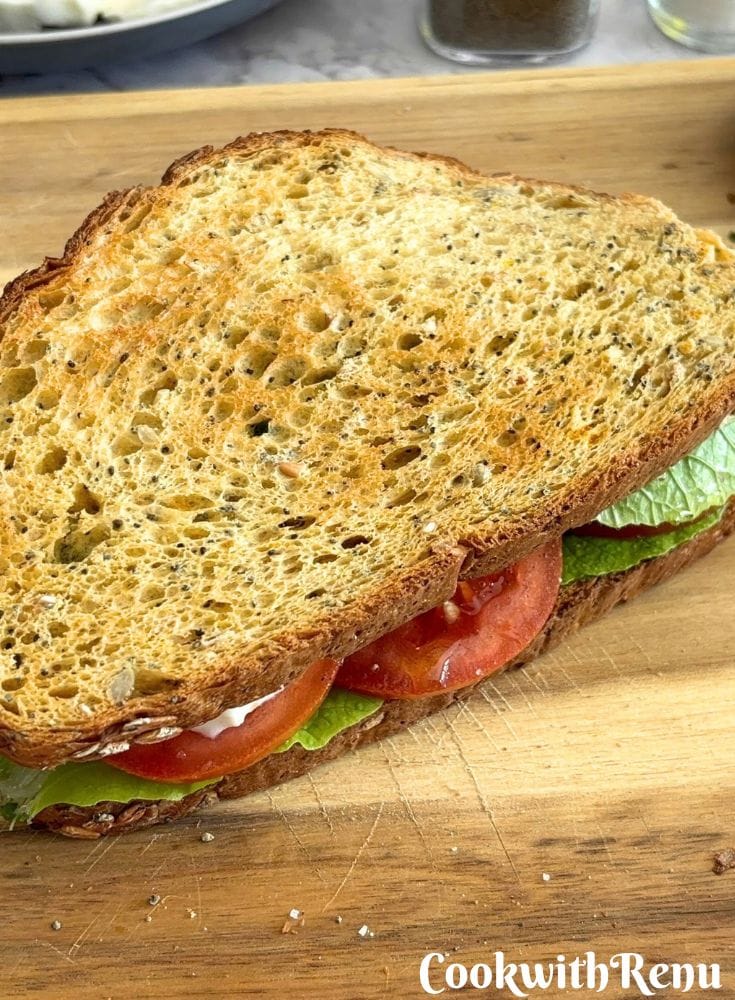 Basil Chutney Caprese Sandwich served on a cream cheese board.