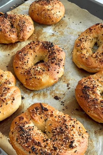 Baked Homemade Everything Bagel on a baking tray.