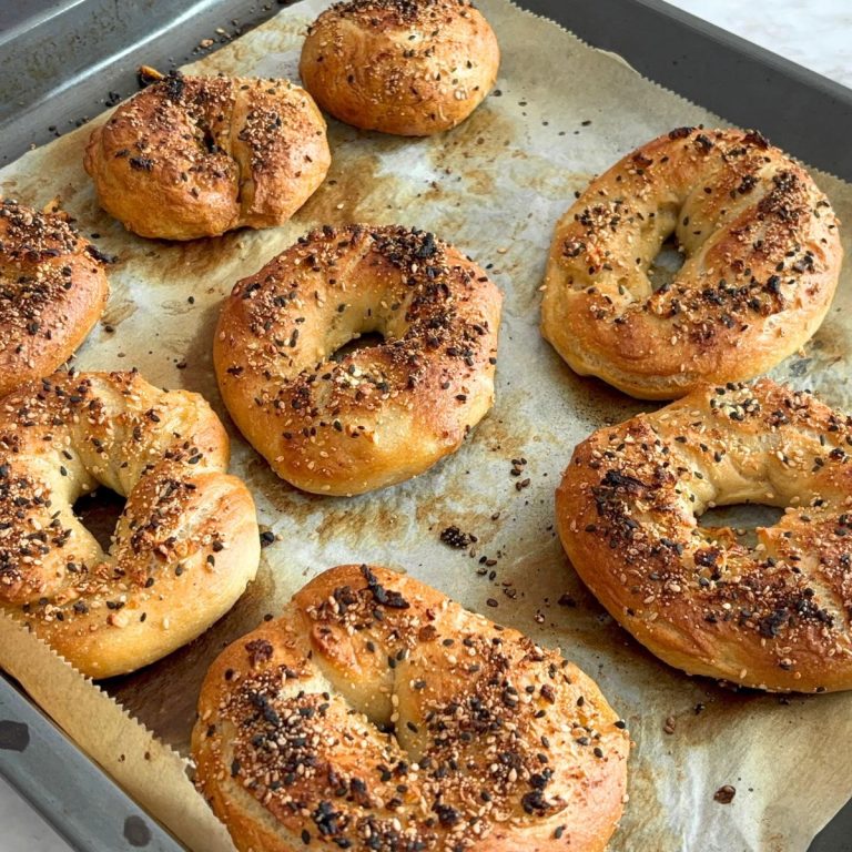 Baked Homemade Everything Bagel on a baking tray.