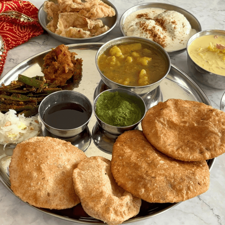 Traditional UP Shradh Thali served with 11 different items in a steel plate with steel bowls.